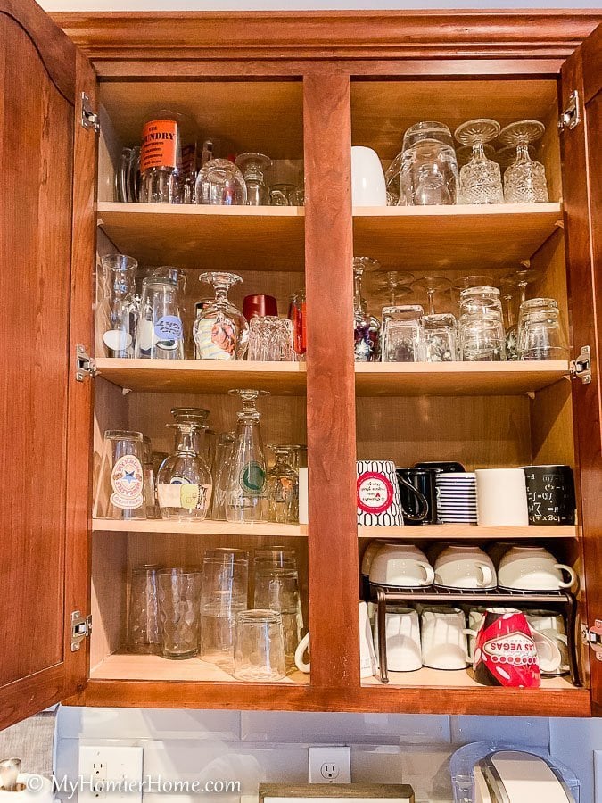 How to Organize Kitchen Cabinets-29 How to organize your kitchen cabinets using clear and simple strategies to tackle kitchen cabinet dysfunction without losing your mind. This is the before photo of the massive amount of cups we had in one cabinet.