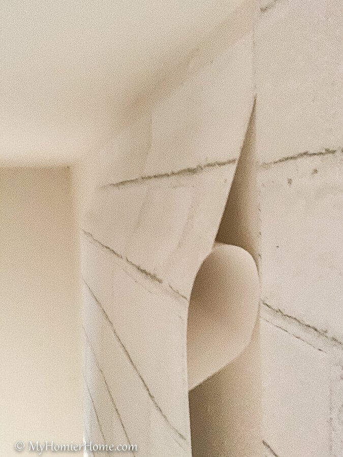 how to hang peel and stick wallpaper-10 Slowly pull the backing down as you squeegee from the center out.