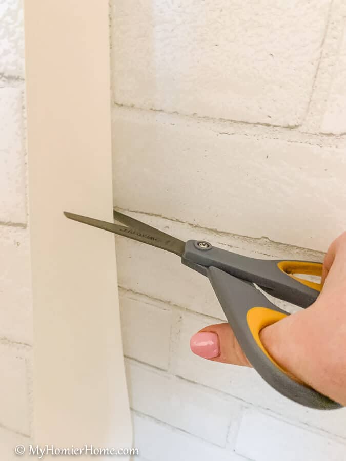 how to hang peel and stick wallpaper-16 You may need to cut the excess off if it begins to be too much paper before reaching the bottom of your wall.