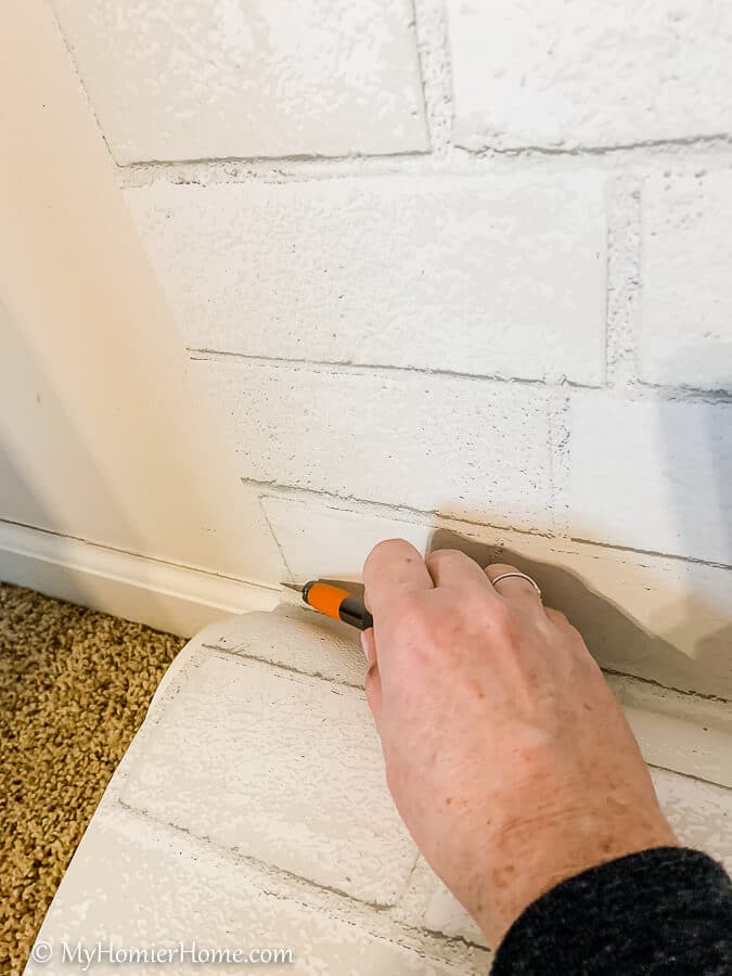 how to hang peel and stick wallpaper-17 Use your X-acto knife to make a perfect cut following the baseboard.