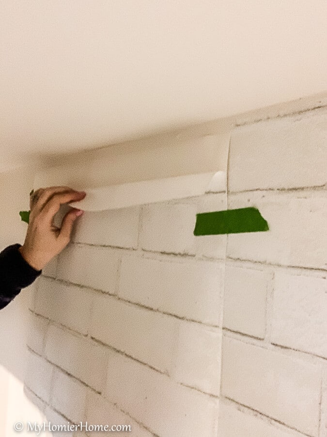 how to hang peel and stick wallpaper-7 Take the backing off of the peel and stick wallpaper just at the top to start.