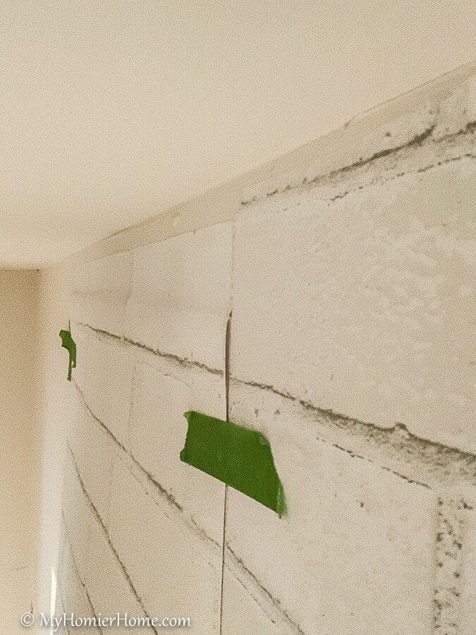 how to hang peel and stick wallpaper-9 Stick the peel and stick wallpaper to the wall at the top.